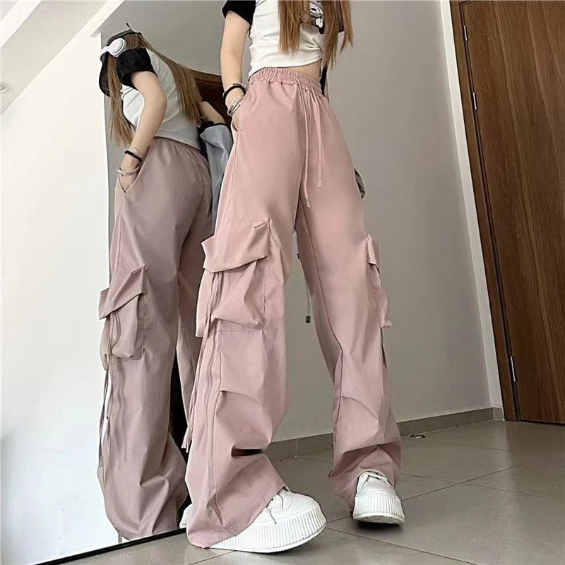 Trendy women’s Y2K cargo pants with oversized pockets, drawstring waist, and a baggy streetwear pink