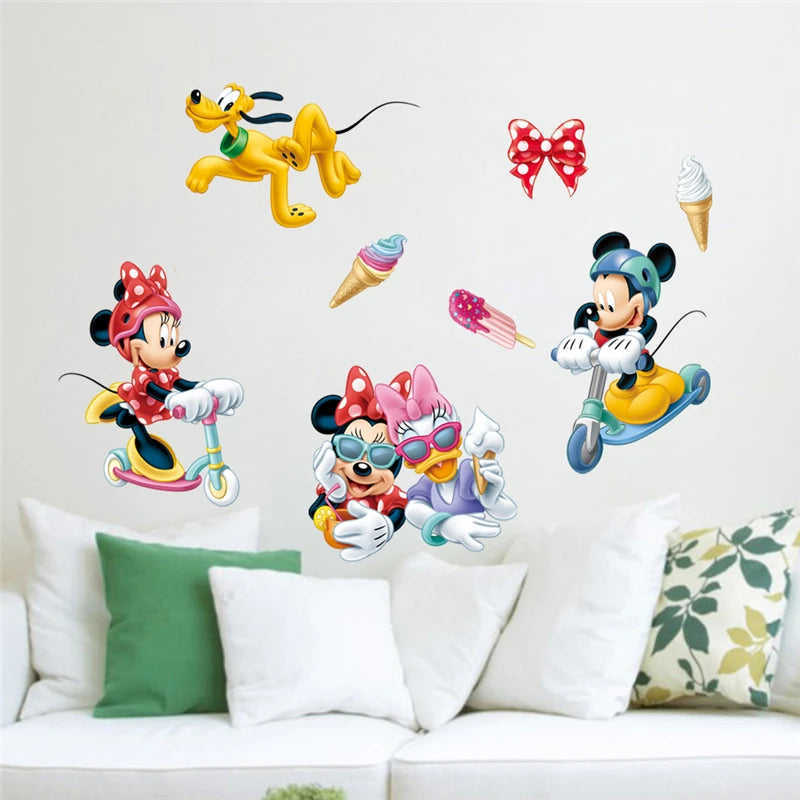 Cartoon character wall stickers on a white wall above a sofa with decorative pillows.