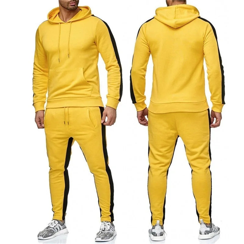Three men's 2-piece tracksuits in black with red stripes, red with black stripes, and yellow with black stripes. Each suit consists of a long-sleeve zip-up top and elastic drawstring pants.