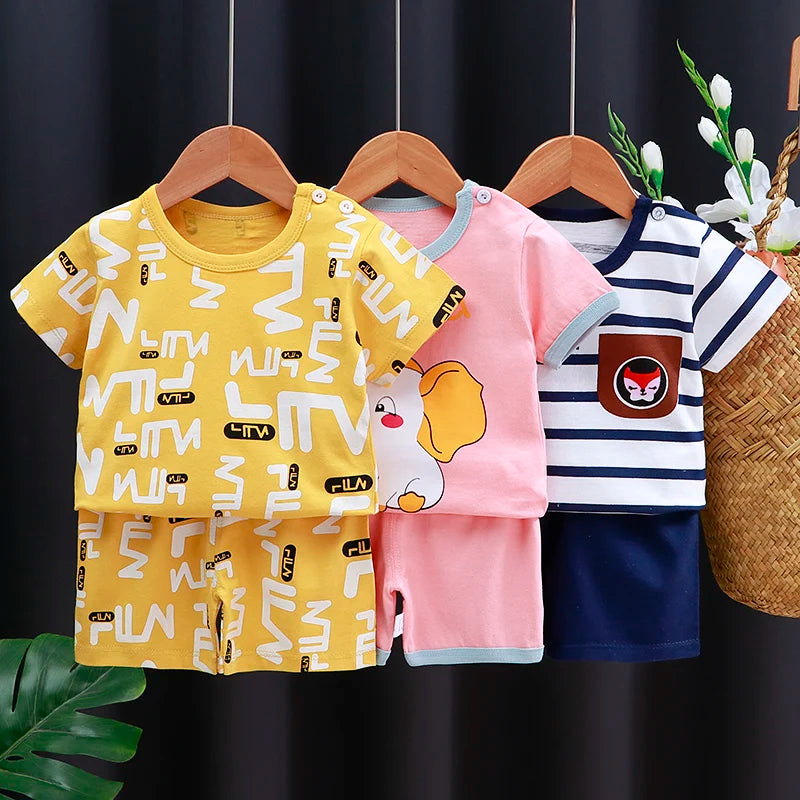 Three children's shirts on hangers with a dark background