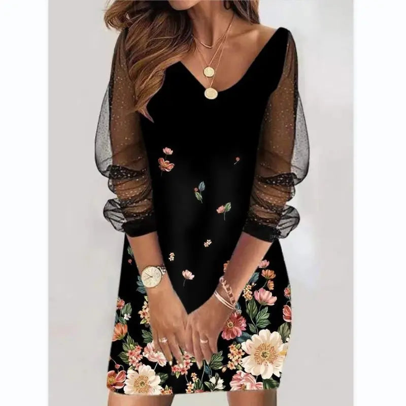 Black dress with floral patterns and sheer sleeves worn by a model.