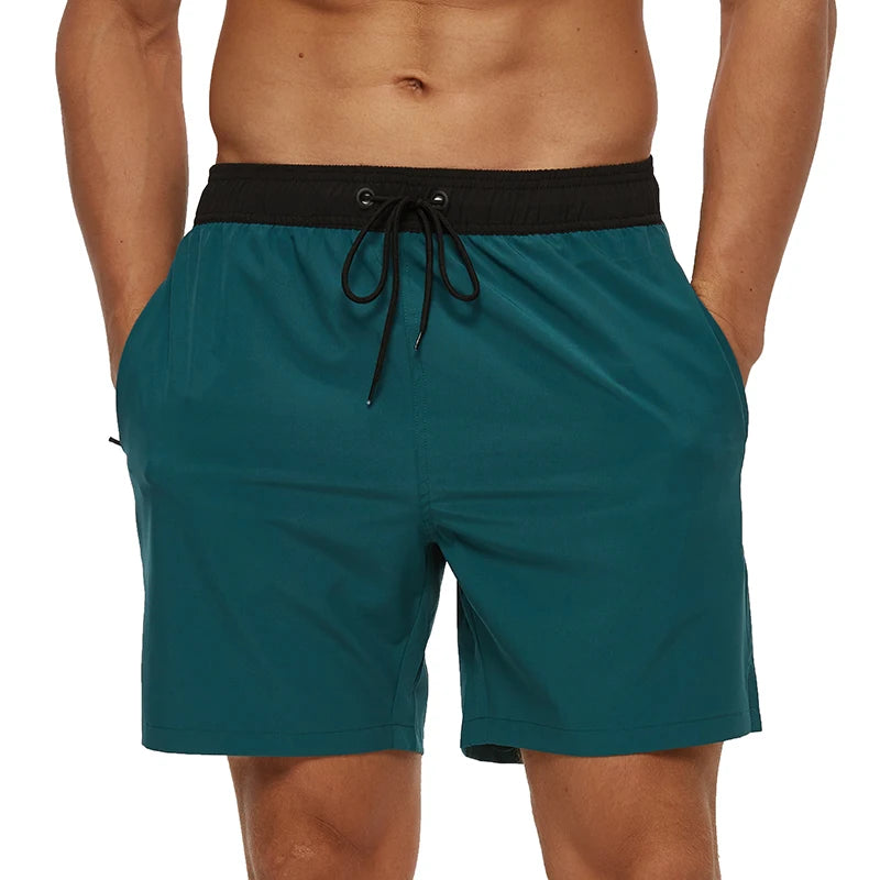 Teal swim shorts with black drawstring on a white background