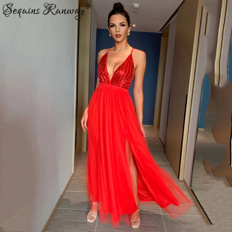 Woman in a red evening gown standing in a hallway.