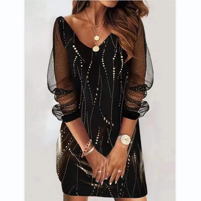Black dress with sheer sleeves worn by a person on a white background