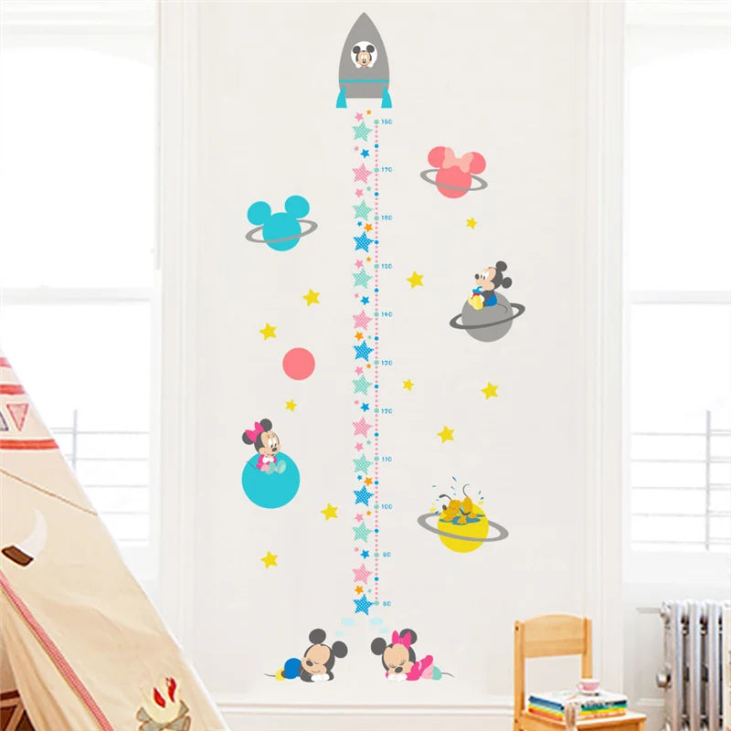 Children's growth chart with cartoon characters on a wall in a room.