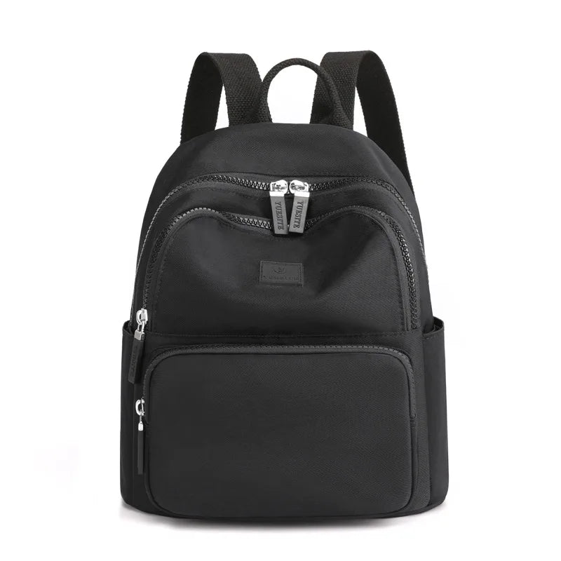 Black backpack with silver zippers on a white background