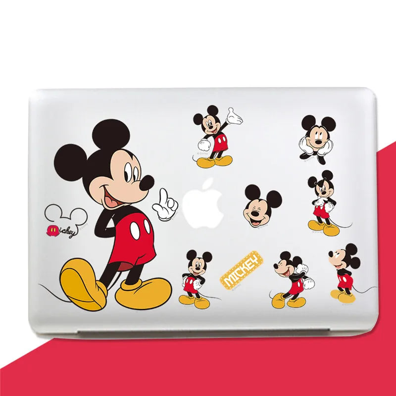 Laptop with multiple Mickey Mouse decals on a white background
