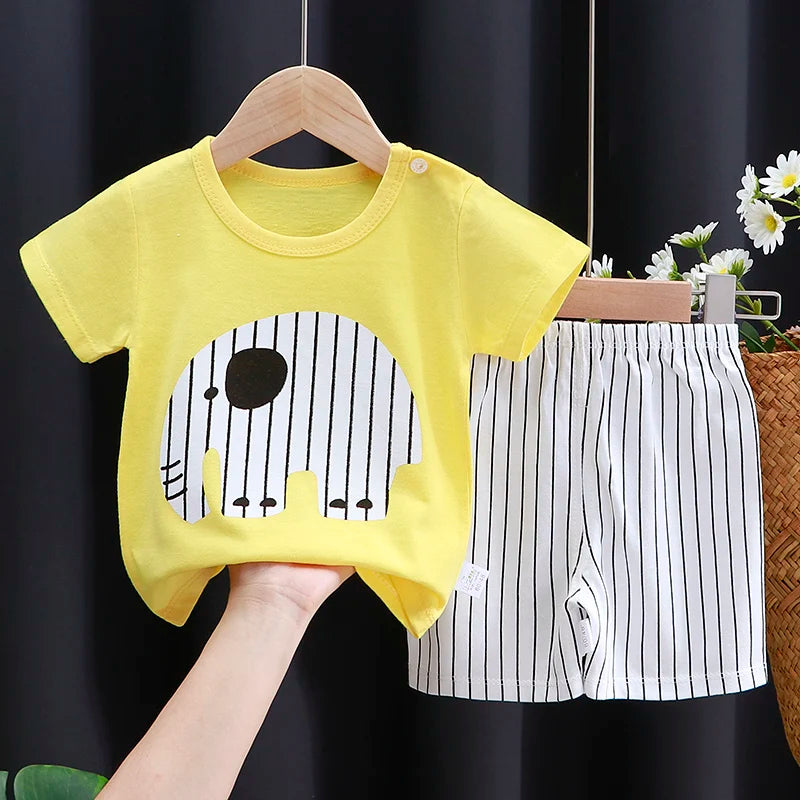Yellow t-shirt with a black and white design on a hanger against a dark background.