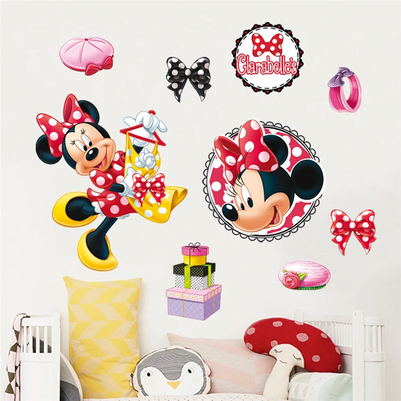 Minnie Mouse-themed wall stickers on a wall with a child's bed and pillows.