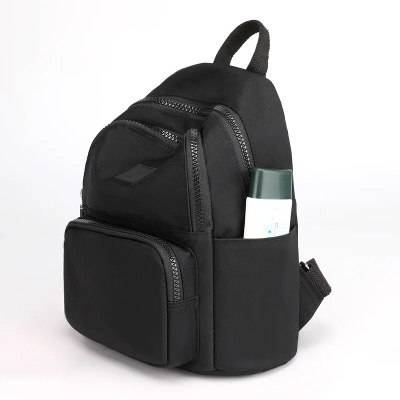 Black backpack with a pocket on a white background