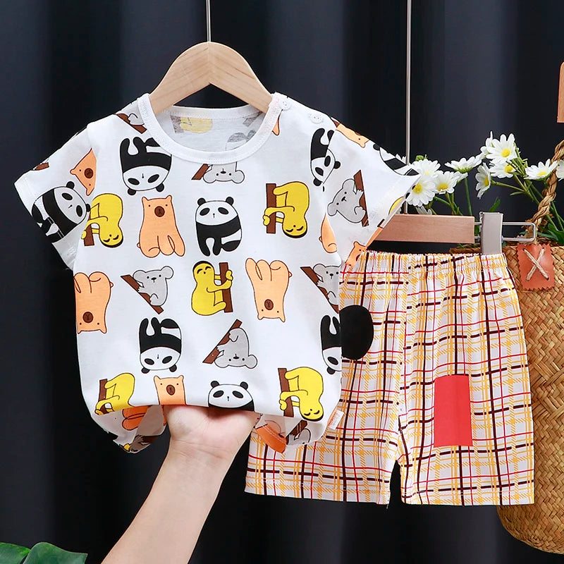 Children's outfit with panda pattern shirt and plaid shorts on a dark background
