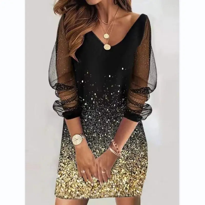 Black and gold dress with sheer sleeves on a white background