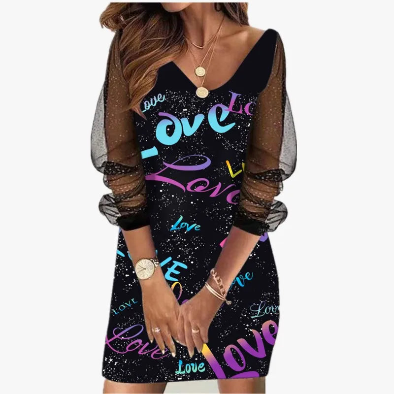 Black dress with colorful 'love' text worn by a model on a white background