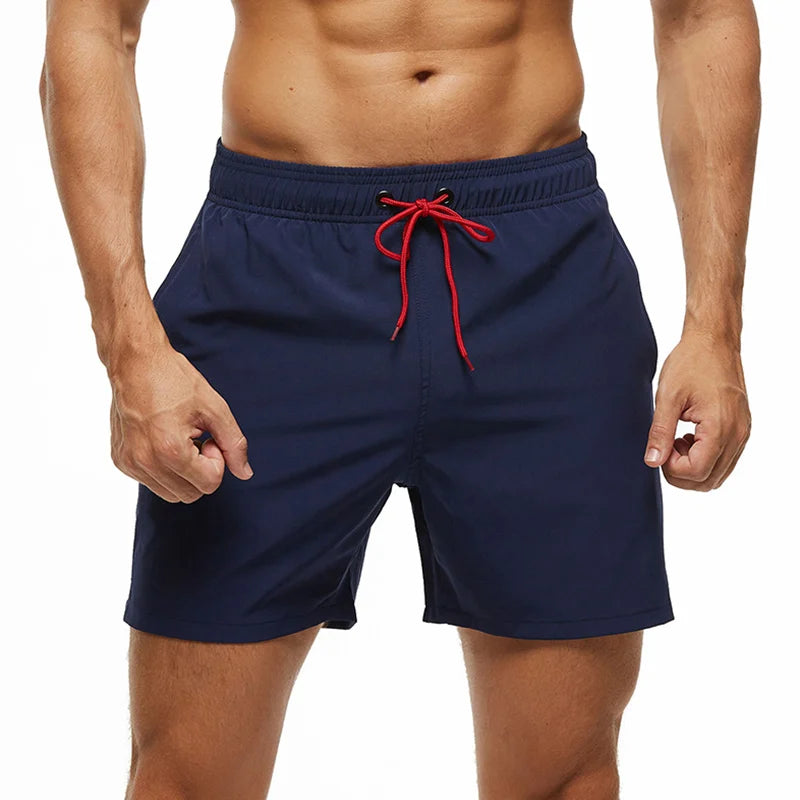 Navy blue swim shorts with a red drawstring on a white background