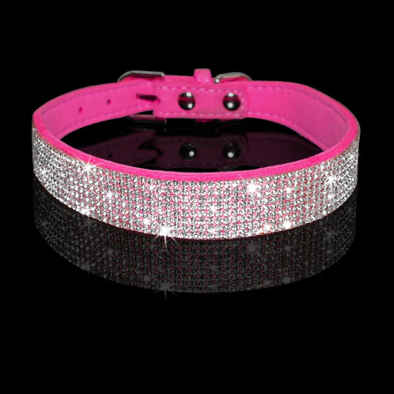 Pink dog collar with rhinestone embellishments on a black background
