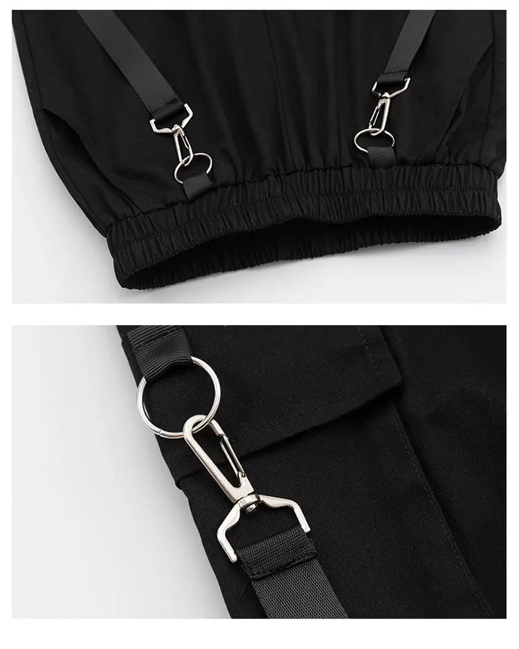 Close-up of black pants with silver metal hooks on a white background