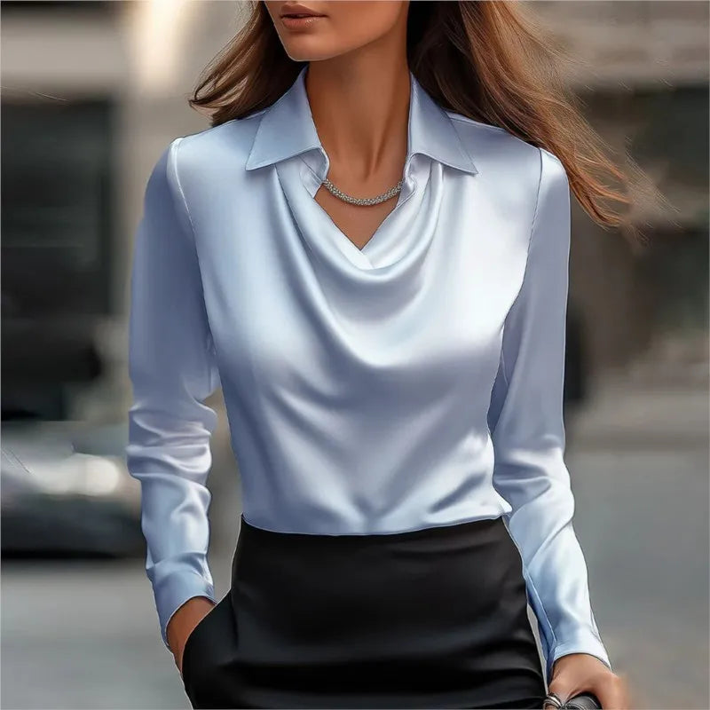 Woman wearing a light blue blouse with a blurred background