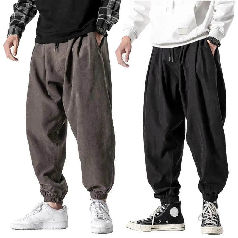 Two pairs of baggy pants in gray and black on a white background.