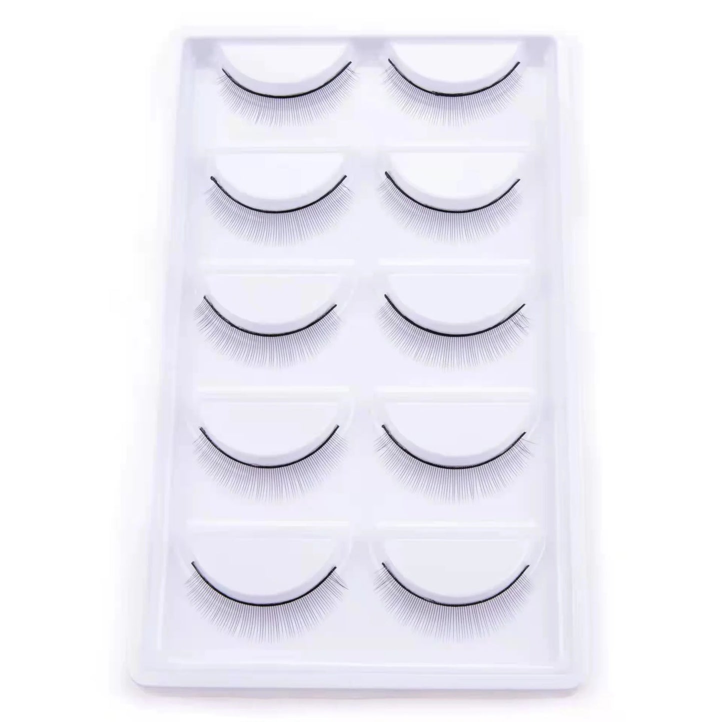 Set of false eyelashes in a clear plastic case on a white background