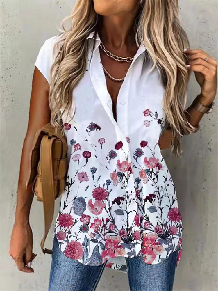 Woman wearing a white blouse with floral patterns against a neutral background