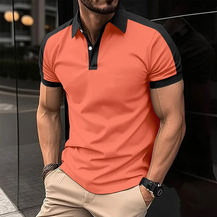 A man wearing a red and black patchwork polo shirt with short sleeves and a collar.