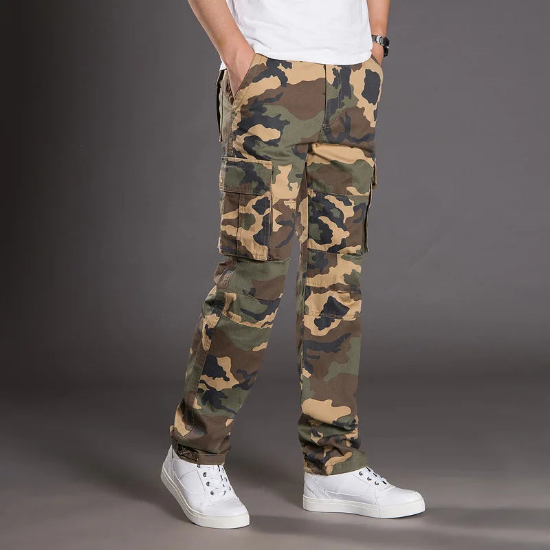 Camouflage pants worn by a person on a gray background