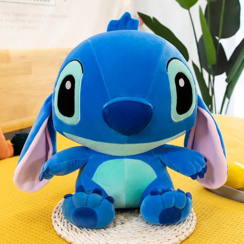 Blue plush toy with large ears on a yellow surface