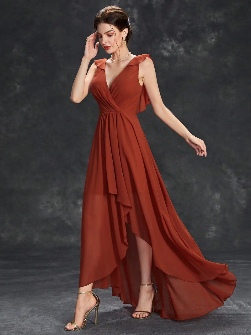 Woman wearing a rust-colored dress against a dark background