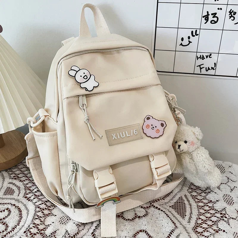 Beige backpack with cute bear patches on a lace tablecloth