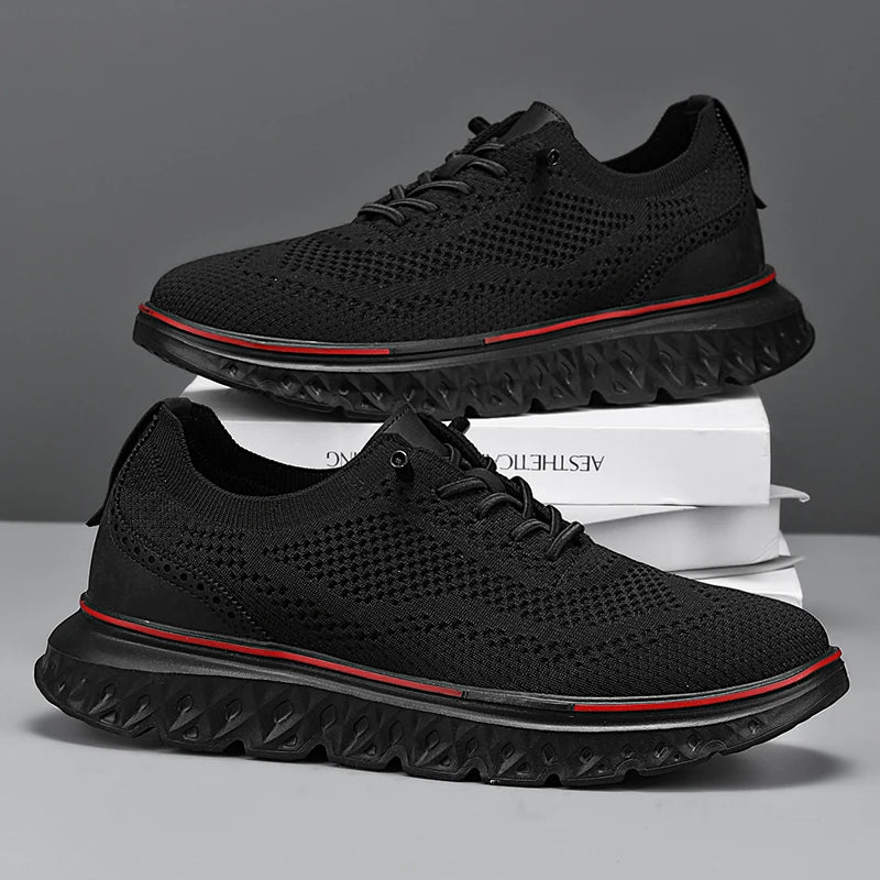 Black athletic shoes with red accents on a gray background