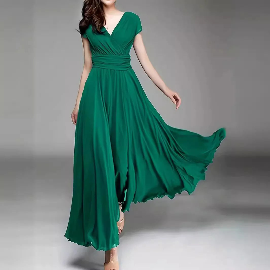 Green evening gown on a model against a gray background