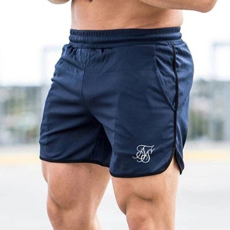 Navy blue athletic shorts with a logo on a blurred background