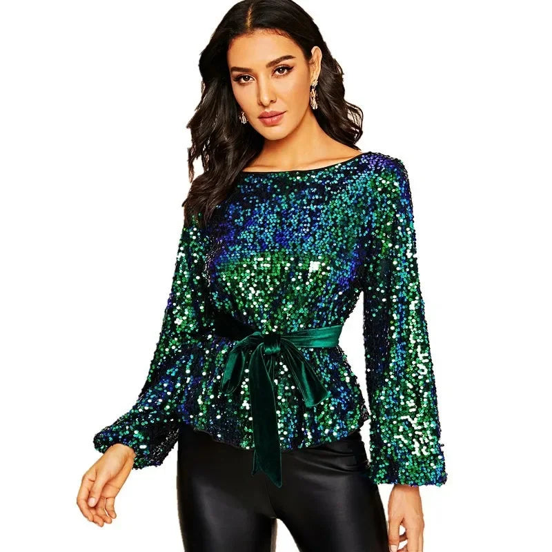 Woman wearing a green sequin top with a belt on a white background