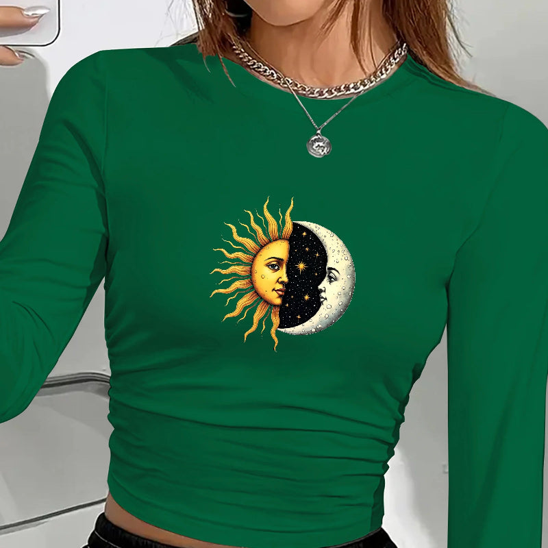 Green long-sleeve shirt with sun and moon design worn by a person.