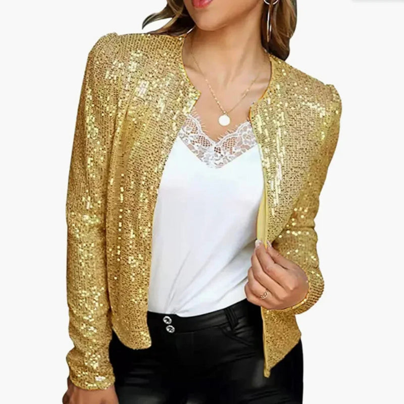 Gold sequin cardigan over a white top and black pants on a white background