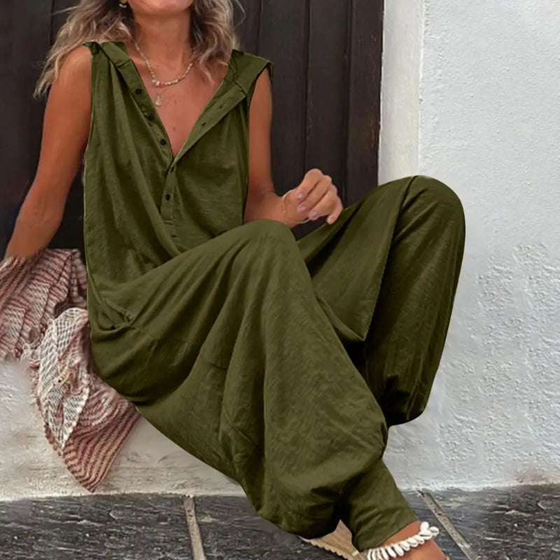 Person wearing a green jumpsuit sitting on a step.
