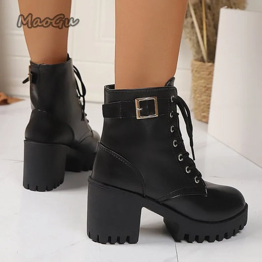 Black platform boots with block heels on a light background