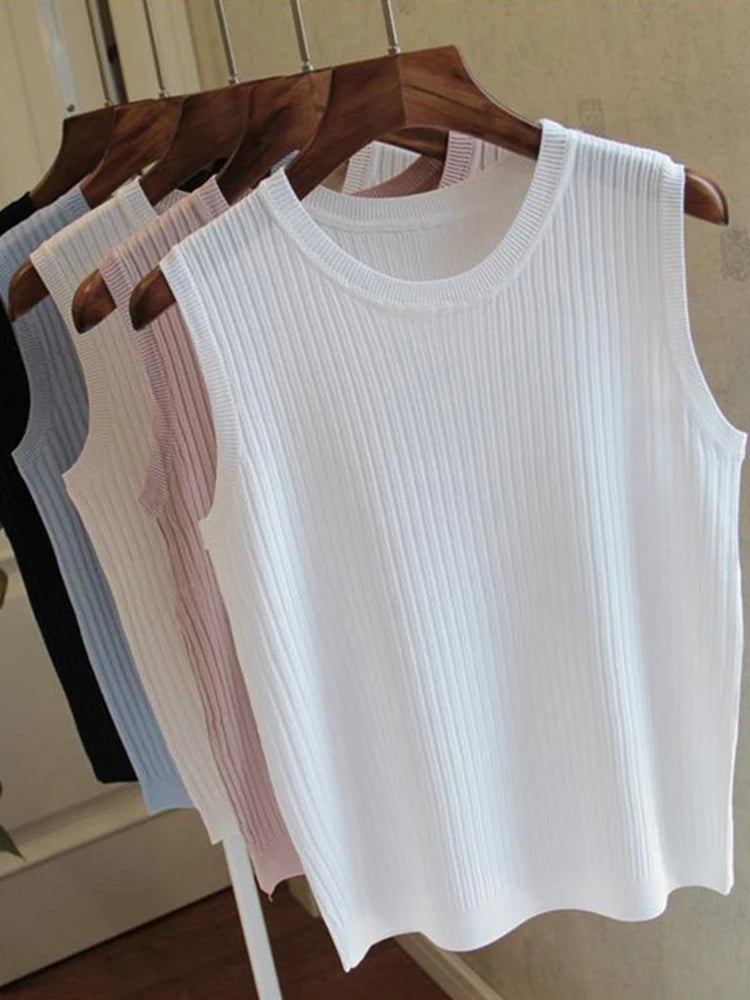 White ribbed tank top on a hanger with other colors in the background