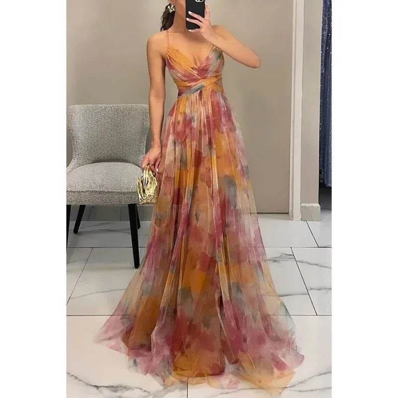 Woman wearing a colorful floral dress taking a mirror selfie.