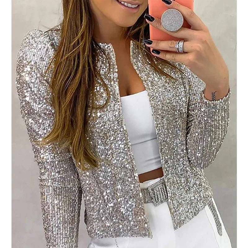 Person wearing a silver sequin jacket taking a mirror selfie.