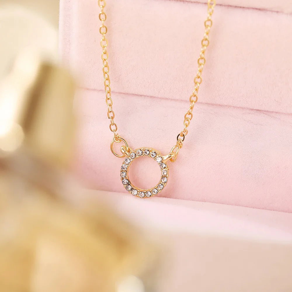 Golden crystal circle pendant necklace for women – elegant trendy jewelry on pink
