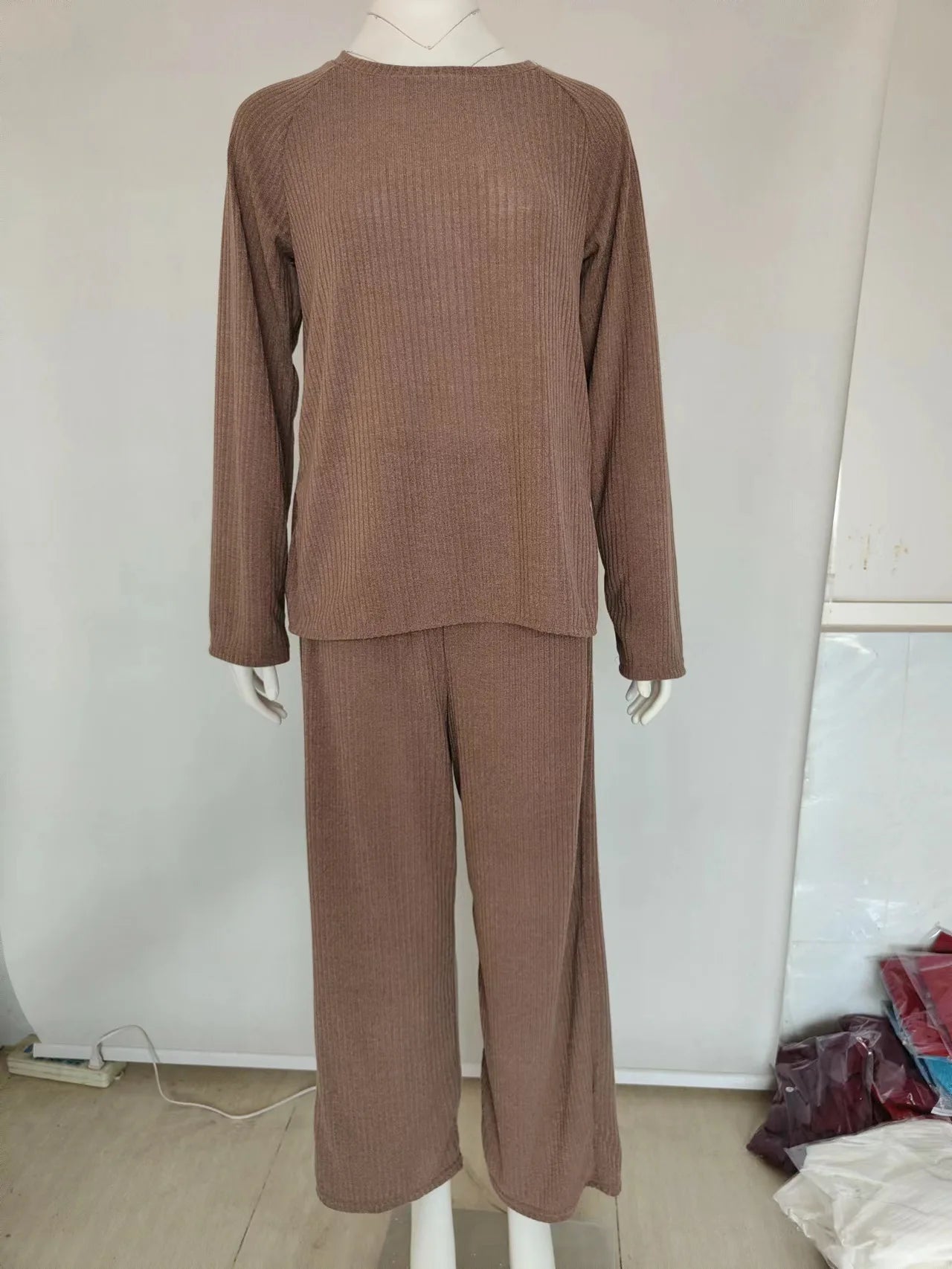 Brown ribbed sweater and pants set on a mannequin against a plain background