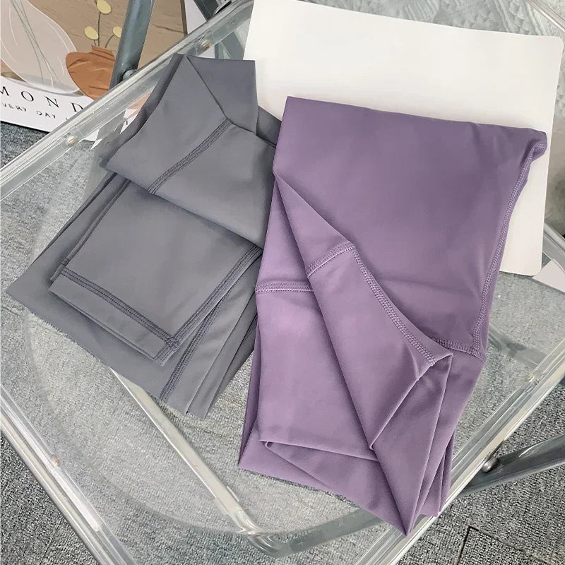 Folded gray and purple fabric on a glass surface