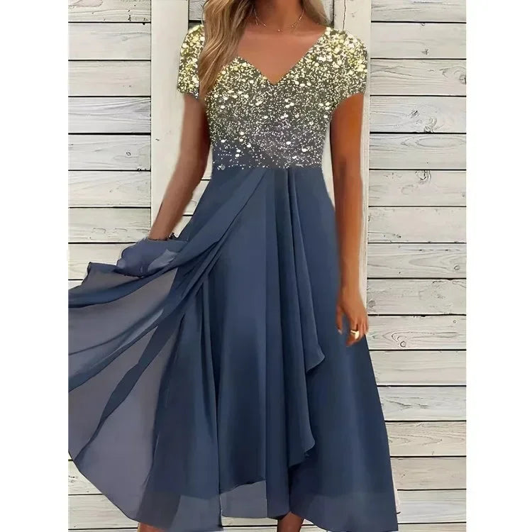 Blue dress with a sequined top against a wooden background