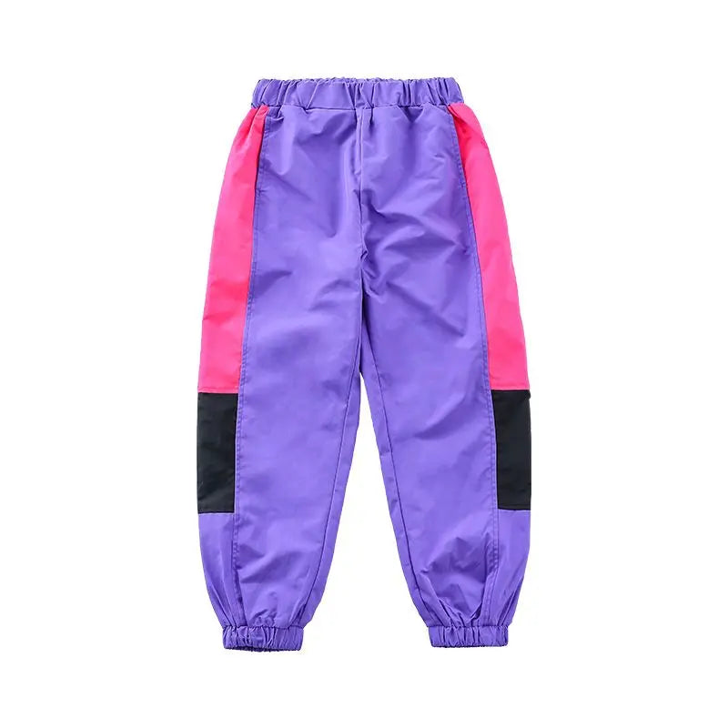 Purple pants with pink and black accents on a white background