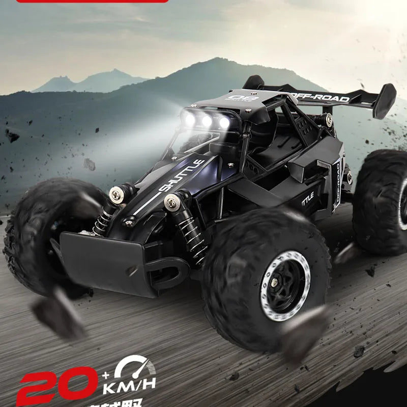 Black off-road RC car with large wheels on a mountainous background