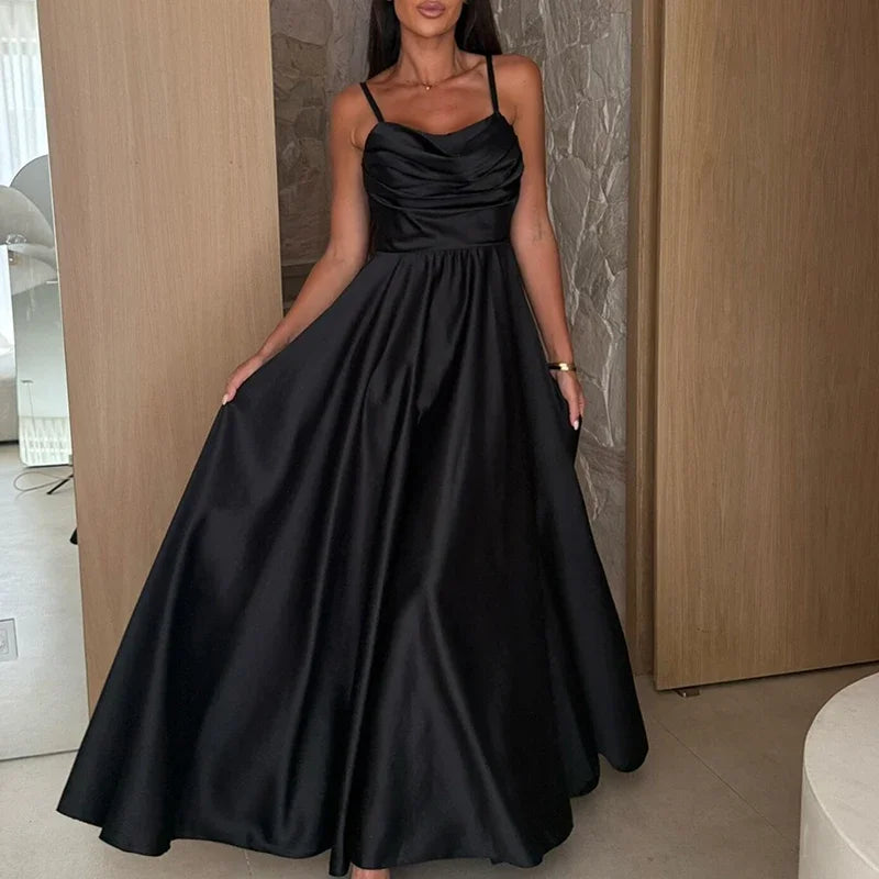 Woman wearing a black satin dress in an indoor setting