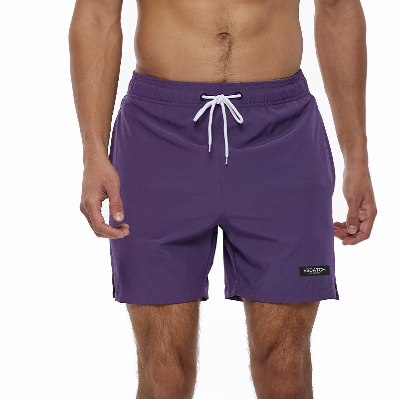 Purple swim shorts with a white drawstring on a white background