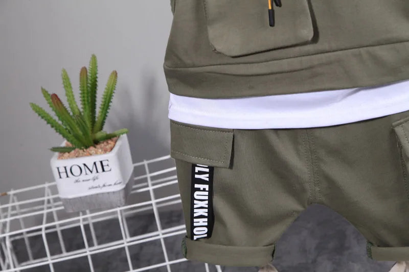 Green cargo shorts with a visible brand label on a gray background