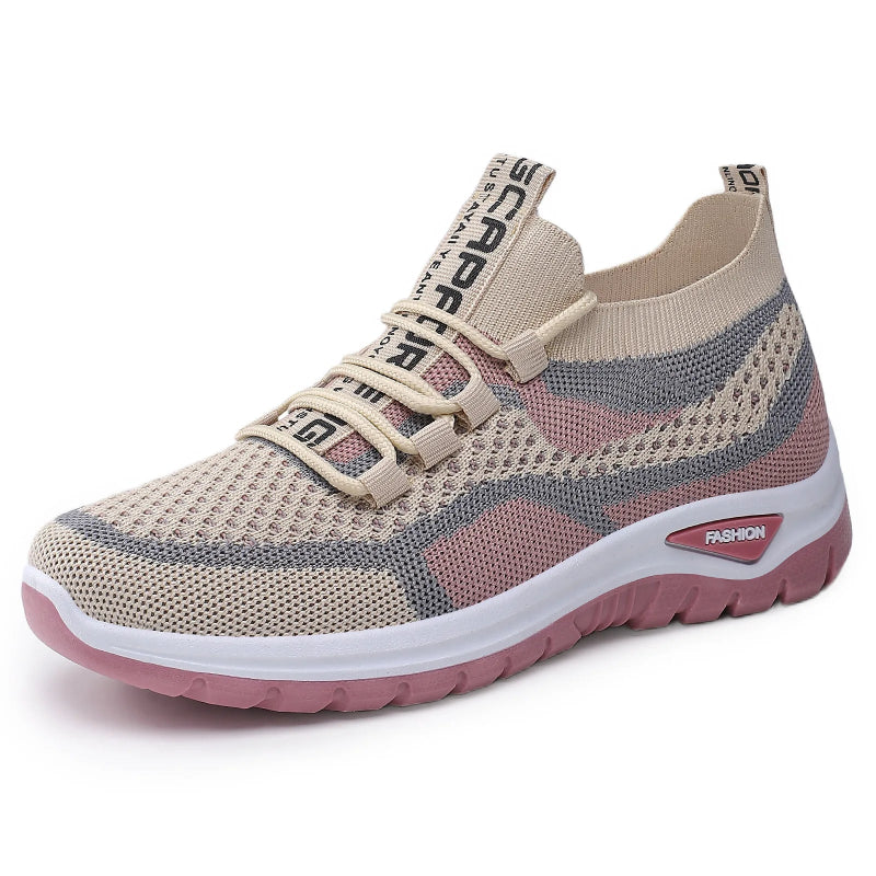 Beige and pink sneaker with mesh design on a white background